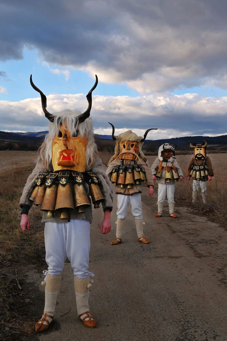 Group of kukeri at sunset in Bulgaria