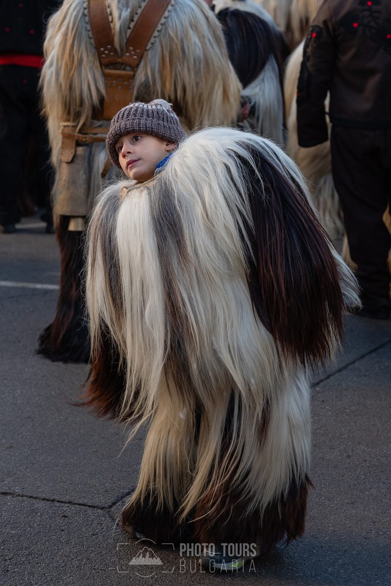 Boy with traditional costume at Surva festival Bulgaria