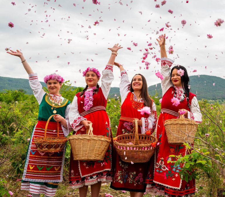 Young ladies trowing rose petals at Rose festival Bulgaria