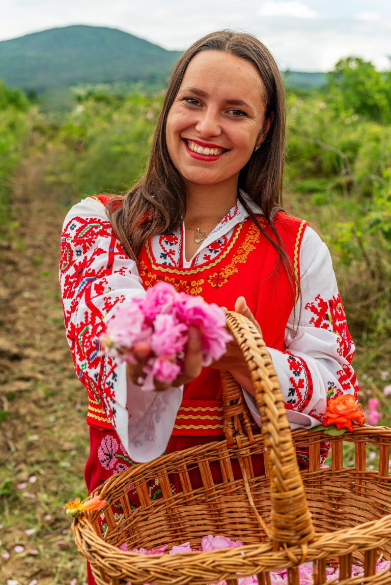 Young lady with traditional costume and rose blossoms Bulgaria