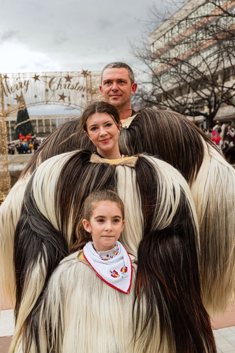 Family preserving Bulgarian folklore traditions at a Kukeri festival