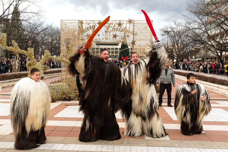 Dynamic kukeri performance photographed at a Bulgarian winter folklore festival